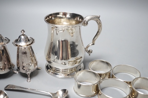 A George II silver baluster mug, John Payne, London, 1752, 97mm, together with five silver napkin rings, two silver condiment spoons and two silver pepperettes, 14oz.